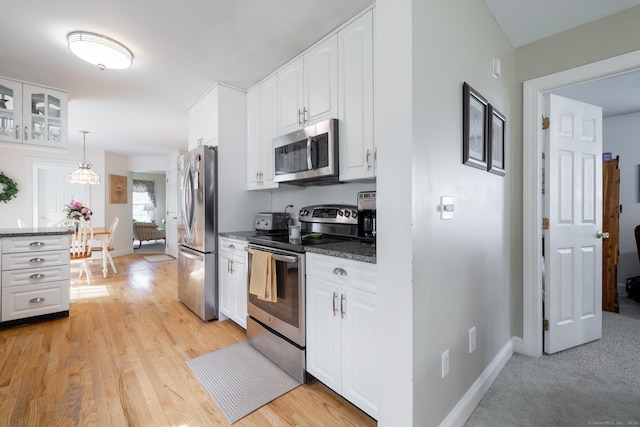191 Pond View Dr, Watertown, CT 06795 - kitchen with stainless steel appliances, dark countertops, white cabinets, and baseboards