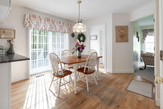 191 Pond View Dr, Watertown, CT 06795 - dining area with light wood finished floors, baseboards, and a chandelier