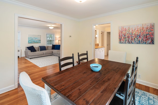 94 Mulberry St, Stamford, CT 06907 - dining space featuring radiator heating unit, ornamental molding, and light wood-style flooring