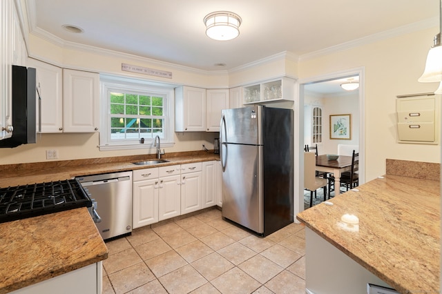 94 Mulberry St, Stamford, CT 06907 - kitchen featuring stainless steel appliances, crown molding, white cabinets, light tile patterned flooring, and light stone counters