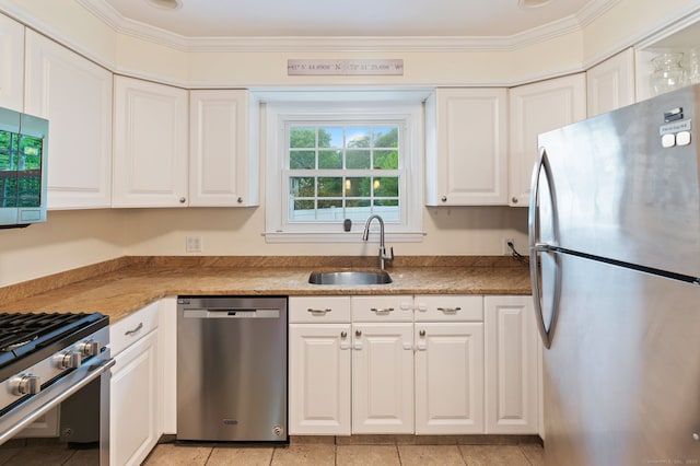 94 Mulberry St, Stamford, CT 06907 - kitchen with stainless steel appliances, white cabinets, crown molding, light tile patterned floors, and light countertops