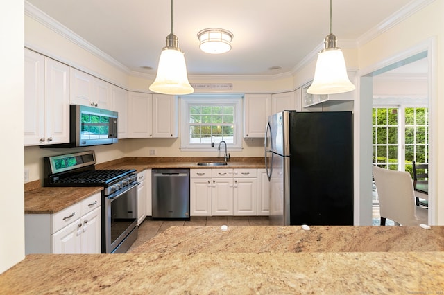 94 Mulberry St, Stamford, CT 06907 - kitchen featuring stainless steel appliances, ornamental molding, white cabinetry, light stone countertops, and hanging light fixtures