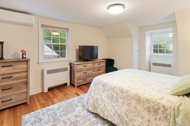 94 Mulberry St, Stamford, CT 06907 - bedroom with radiator heating unit, an AC wall unit, and light wood-style floors