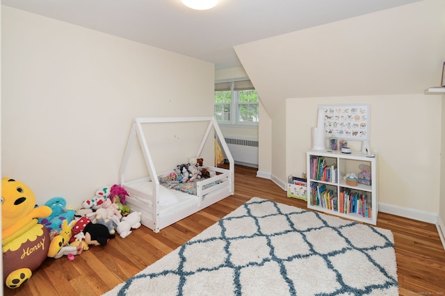 94 Mulberry St, Stamford, CT 06907 - rec room with radiator heating unit and wood finished floors