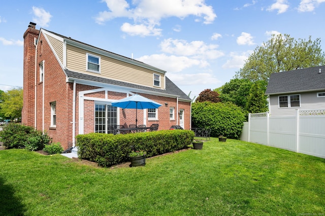 94 Mulberry St, Stamford, CT 06907 - back of property featuring a chimney, brick siding, and roof with shingles
