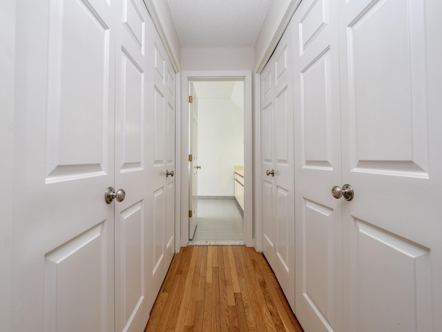 24 Wilton Crst Unit 24, Wilton, CT 06897 - hall with light wood-style floors and a textured ceiling
