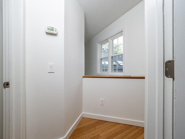 24 Wilton Crst Unit 24, Wilton, CT 06897 - corridor with light wood-type flooring, baseboards, and a textured ceiling