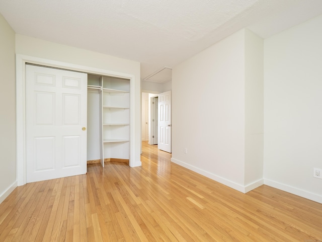 24 Wilton Crst Unit 24, Wilton, CT 06897 - unfurnished bedroom featuring light wood-type flooring, baseboards, and a closet