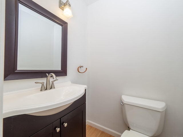 24 Wilton Crst Unit 24, Wilton, CT 06897 - half bathroom with vanity, wood finished floors, toilet, and baseboards