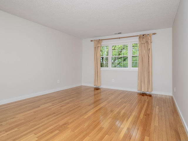 24 Wilton Crst Unit 24, Wilton, CT 06897 - unfurnished room with light wood-style flooring, baseboards, and a textured ceiling