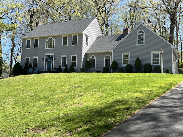 27 Regency Dr, North Haven, CT 06473 - colonial inspired home featuring a chimney, a front yard, and a shingled roof