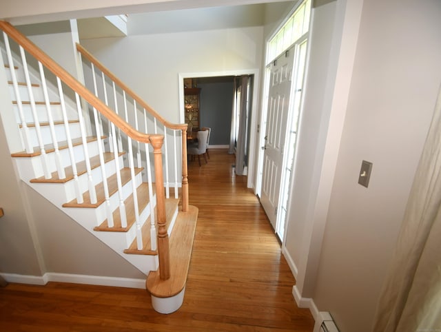27 Regency Dr, North Haven, CT 06473 - hall featuring baseboards, wood finished floors, and stairway