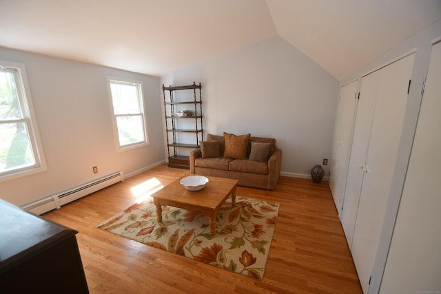 27 Regency Dr, North Haven, CT 06473 - living room with baseboard heating, light wood-type flooring, and vaulted ceiling