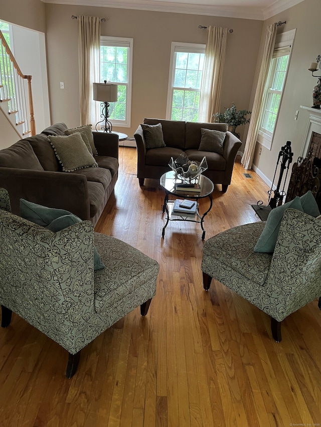 27 Regency Dr, North Haven, CT 06473 - living area with crown molding, wood finished floors, healthy amount of natural light, stairway, and baseboards