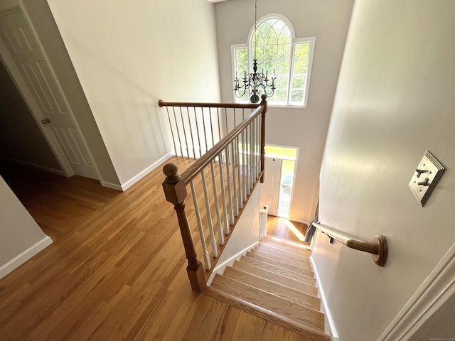 27 Regency Dr, North Haven, CT 06473 - stairway with baseboards, a chandelier, and wood finished floors