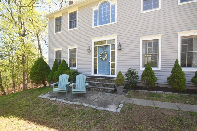 27 Regency Dr, North Haven, CT 06473 - view of front of house featuring a patio and a chimney