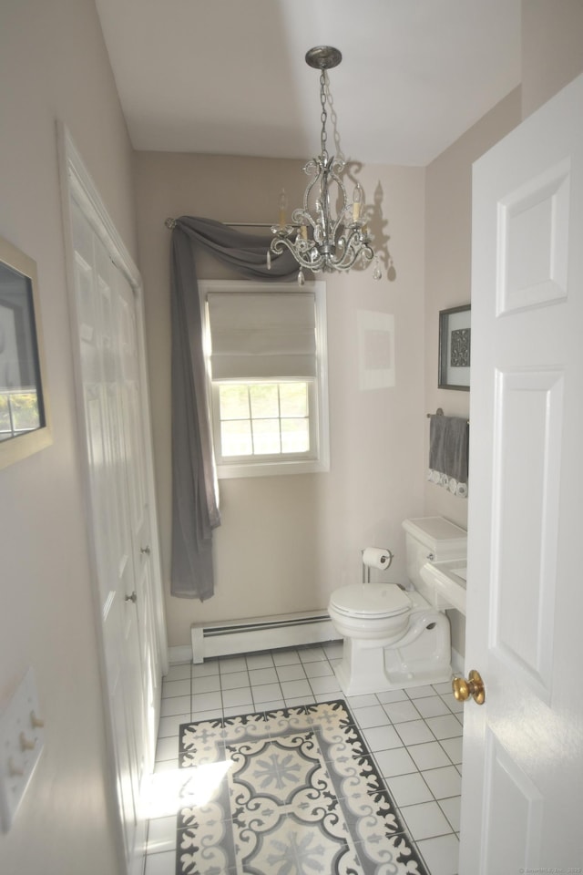 27 Regency Dr, North Haven, CT 06473 - bathroom featuring a baseboard heating unit, a chandelier, toilet, tile patterned floors, and baseboards