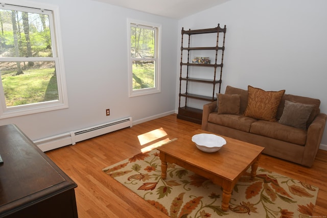 27 Regency Dr, North Haven, CT 06473 - living room with a baseboard heating unit, light wood-type flooring, and vaulted ceiling