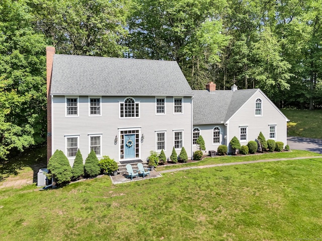 27 Regency Dr, North Haven, CT 06473 - colonial home featuring a chimney, a front lawn, entry steps, and a patio