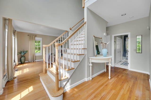27 Regency Dr, North Haven, CT 06473 - stairway featuring wood finished floors, baseboards, and a baseboard heating unit