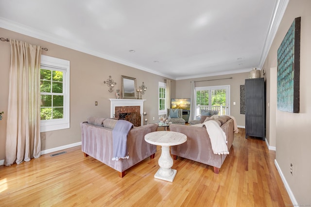 27 Regency Dr, North Haven, CT 06473 - living area with a brick fireplace, light wood-type flooring, baseboards, and ornamental molding