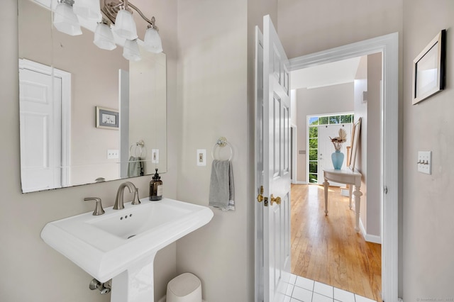 27 Regency Dr, North Haven, CT 06473 - bathroom with a sink, wood finished floors, and baseboards