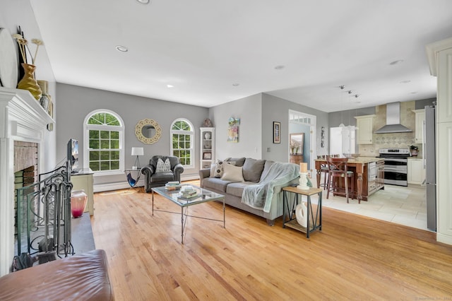 27 Regency Dr, North Haven, CT 06473 - living room with a fireplace, recessed lighting, and light wood finished floors
