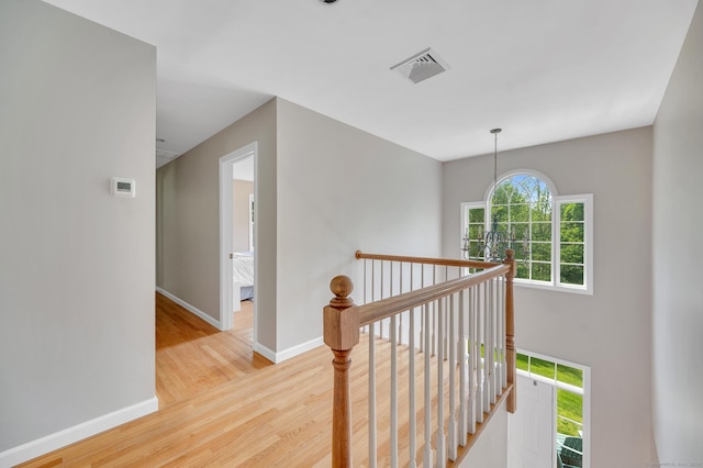 27 Regency Dr, North Haven, CT 06473 - hallway with an upstairs landing, wood finished floors, and baseboards