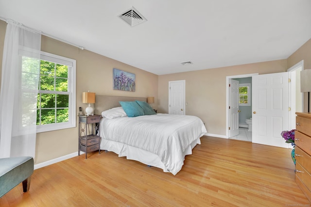 27 Regency Dr, North Haven, CT 06473 - bedroom featuring baseboards, light wood-style flooring, and connected bathroom