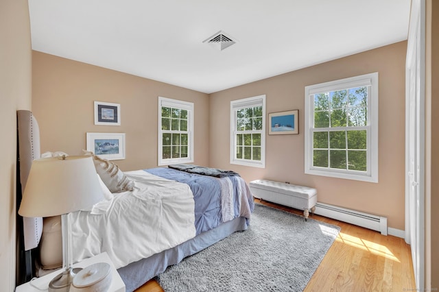 27 Regency Dr, North Haven, CT 06473 - bedroom with baseboard heating, wood finished floors, and baseboards