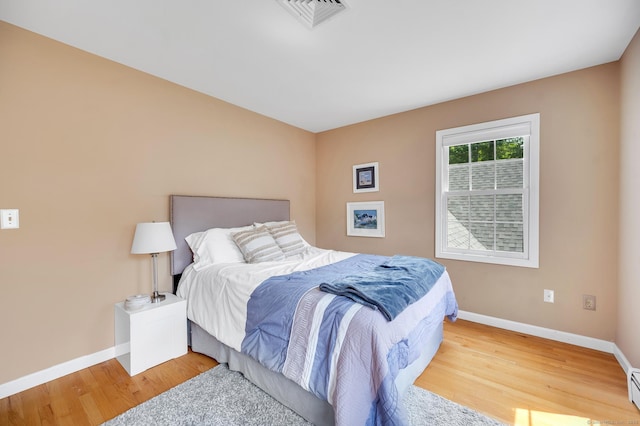 27 Regency Dr, North Haven, CT 06473 - bedroom with light wood-style floors, baseboards, and baseboard heating
