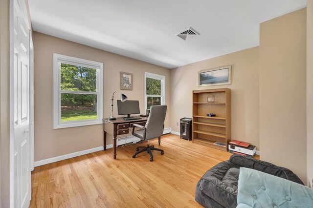27 Regency Dr, North Haven, CT 06473 - home office featuring plenty of natural light, light wood-style floors, baseboards, and a baseboard radiator