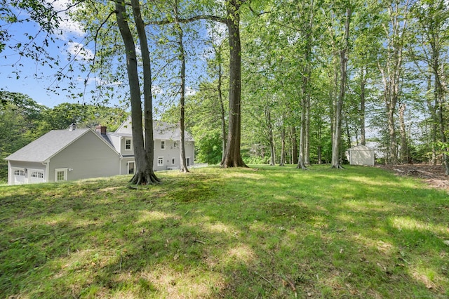 27 Regency Dr, North Haven, CT 06473 - view of grassy yard with a garage