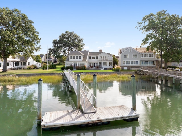 dock area with a water view and a residential view