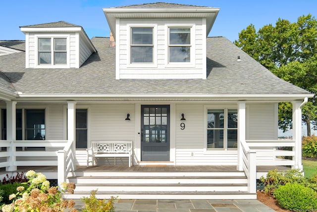 view of front of home featuring a porch and a shingled roof