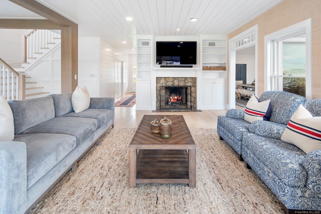 living area with wood finished floors, stairs, recessed lighting, a fireplace, and wooden ceiling
