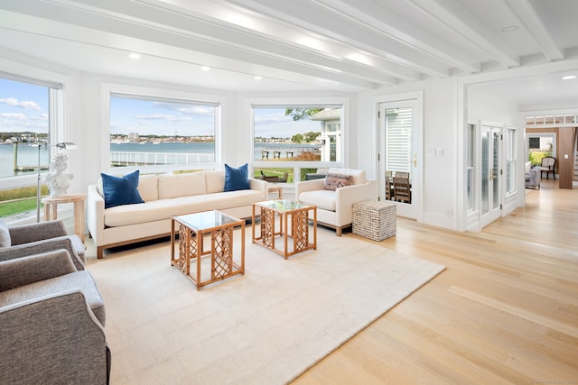 living area featuring light wood-style flooring, beam ceiling, healthy amount of natural light, and recessed lighting