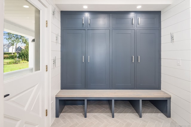 mudroom featuring wood walls and recessed lighting