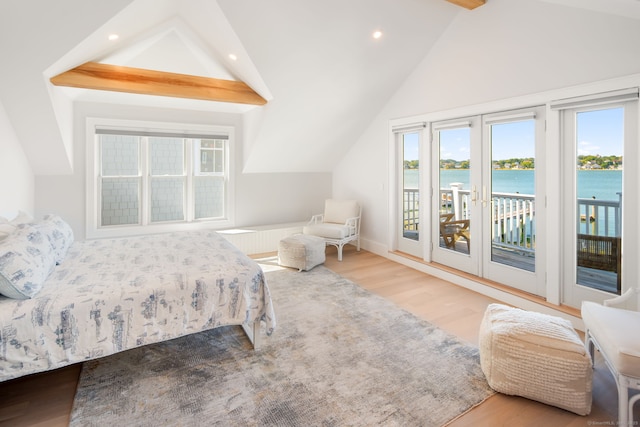 bedroom with access to outside, wood finished floors, recessed lighting, and a water view