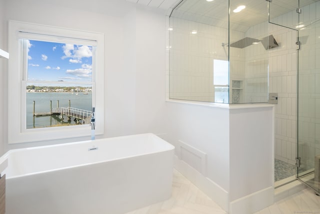 full bathroom with a shower stall, a soaking tub, healthy amount of natural light, recessed lighting, and a water view