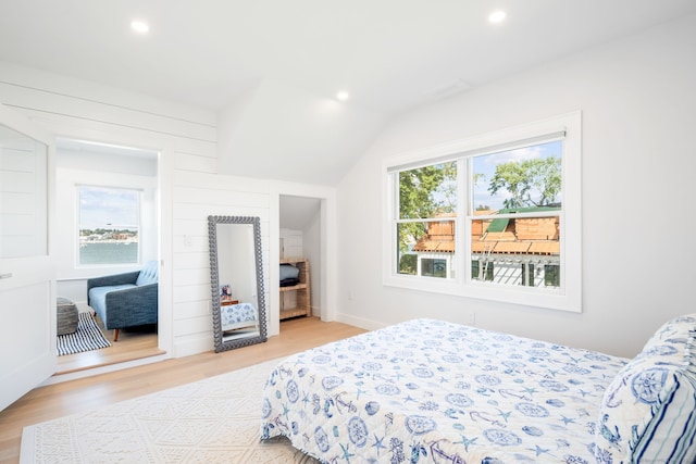 bedroom with recessed lighting, light wood-style floors, and lofted ceiling