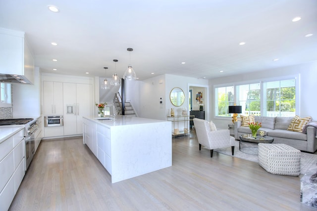 38 Tamarac Rd, Westport, CT 06880 - kitchen with modern cabinets, stainless steel appliances, white cabinets, recessed lighting, and light wood-type flooring