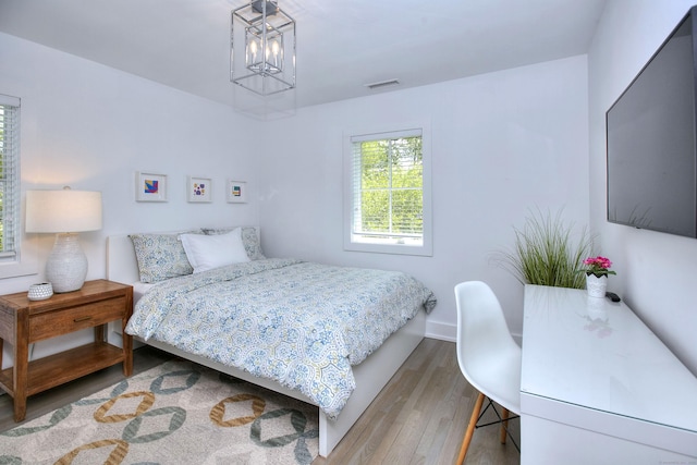 38 Tamarac Rd, Westport, CT 06880 - bedroom with wood finished floors, a chandelier, and baseboards