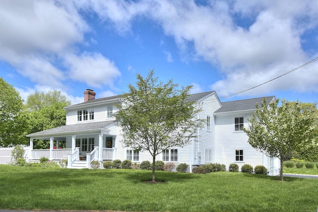 38 Tamarac Rd, Westport, CT 06880 - rear view of property with a chimney, a yard, covered porch, and roof with shingles