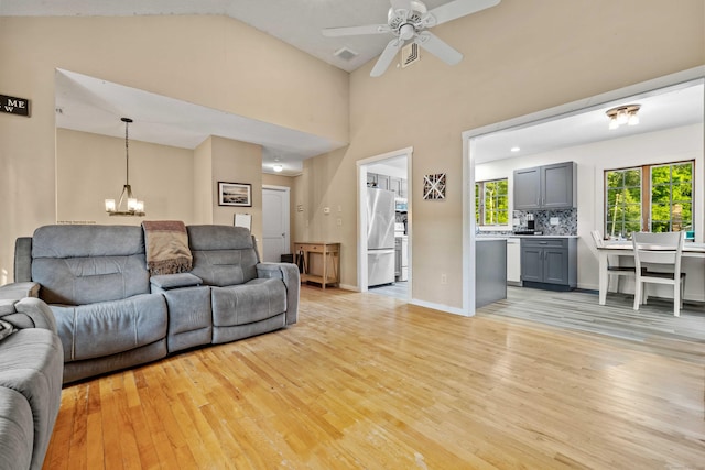 11 Osprey Ln, East Lyme, CT 06357 - living area featuring light wood-type flooring, ceiling fan, and a chandelier