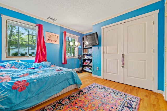 11 Osprey Ln, East Lyme, CT 06357 - bedroom with wood finished floors, a textured ceiling, and baseboards