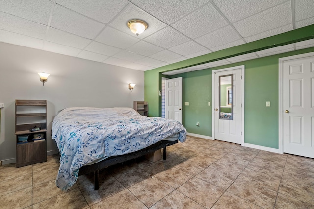 11 Osprey Ln, East Lyme, CT 06357 - bedroom with a drop ceiling, light tile patterned flooring, and baseboards