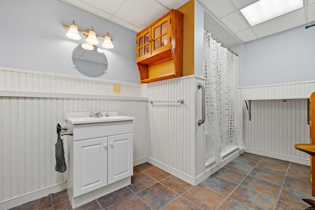 11 Osprey Ln, East Lyme, CT 06357 - bathroom featuring vanity, wainscoting, a drop ceiling, and a shower with curtain