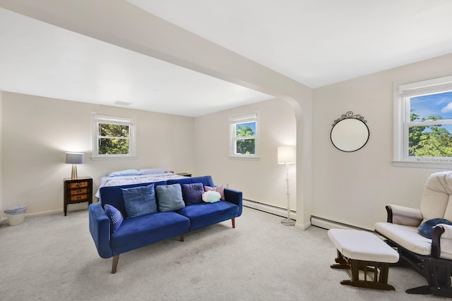 bedroom featuring a baseboard heating unit, carpet floors, multiple windows, and baseboards