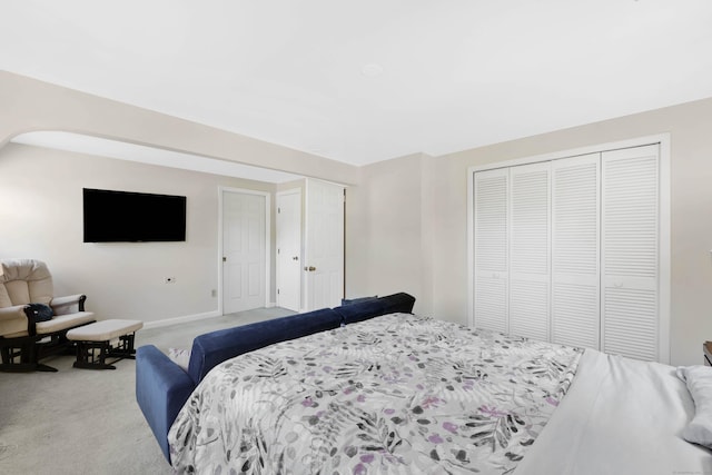 bedroom with light carpet and a closet